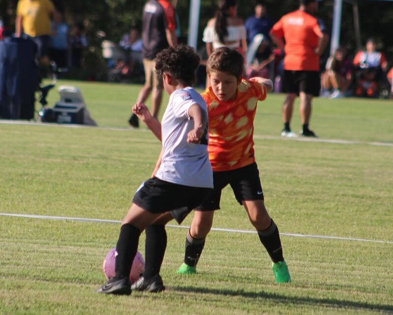 Two players challenging for the ball during a match